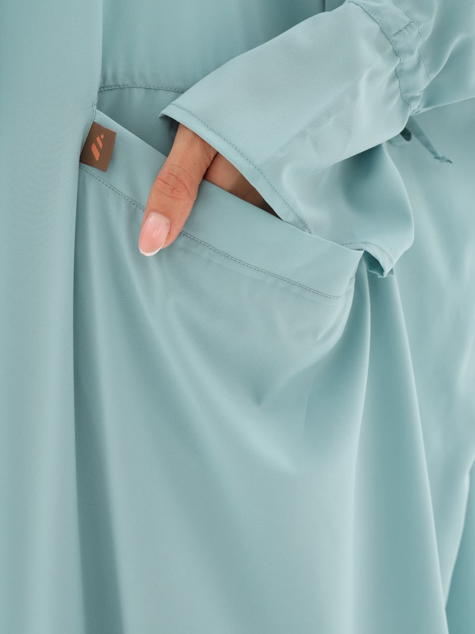 Side pocket and drawstring cuff detail in sage