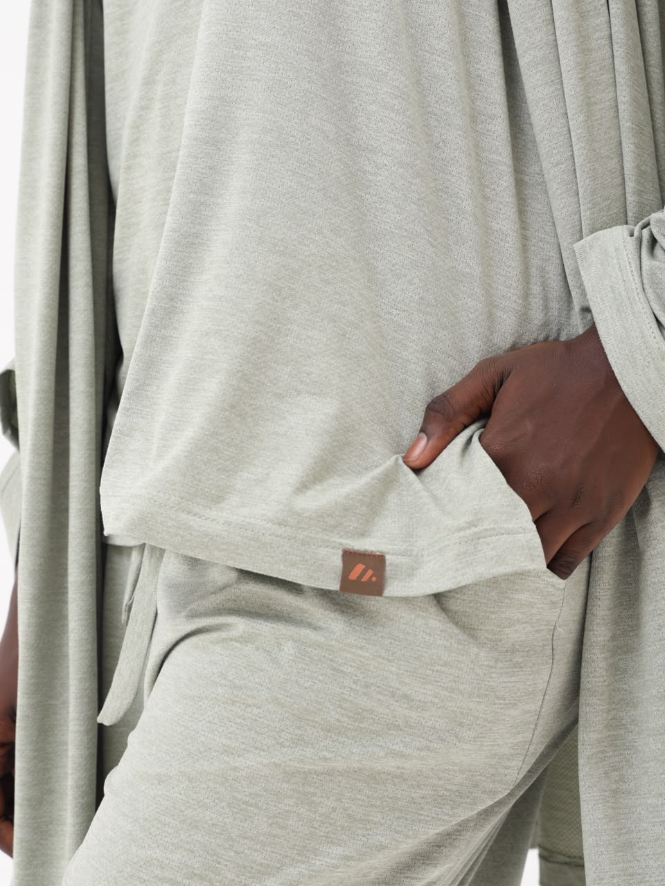Close-up of the side pocket and leather brand label on the sage set